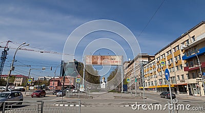City landscape on old buildings mixed up with new ones, road with cars, transport and road signs separated by an alley with green Editorial Stock Photo