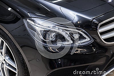 Close-up on a car Mercedes E-class body standing inthe garage box for polishing and removing scratches from the surface. Auto Editorial Stock Photo