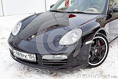 Front view of the 2006 sports porsche boxster s coupe roadster prepared for sale with a polished shiny black body on snow winter Editorial Stock Photo