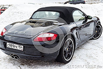 Rear view of the 2006 sports porsche boxster s coupe roadster prepared for sale with a polished shiny black body on snow winter at Editorial Stock Photo
