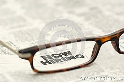 Now Hiring classified ad framed in glasses Stock Photo