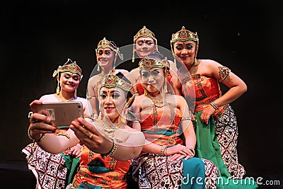 Surabaya indonesia. November 27, 2017. A group of traditional dancers are having selfies using cellphone cameras Editorial Stock Photo