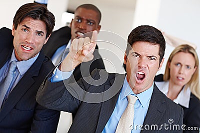 Now thats what I call a hostile takeover. an angry mob of business professionals. Stock Photo