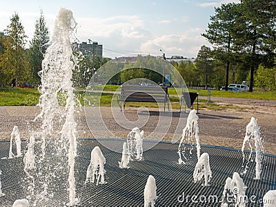 Noyabrsk, Russia - august 30, 2020: Central fountain. Jets of water rise up and scatter into small drops against the background of Editorial Stock Photo