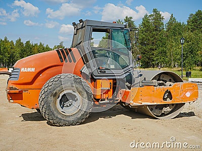 Noyabrsk, Russia - August 9, 2020: The tractor HAMM road roller ground vibratory roller stands on a sandy platform waiting for Editorial Stock Photo