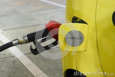 Nozzle fuel Gasohol 95 serving in to small car Stock Photo