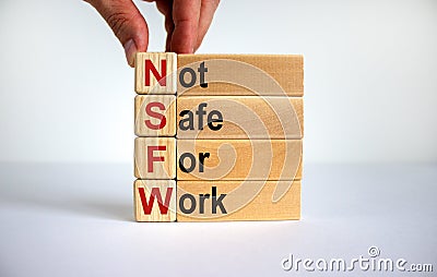 NSFW - not safe for work symbol. Wooden cubes with the word `NSFW - not safe for work` on beautiful white background, copy space Stock Photo