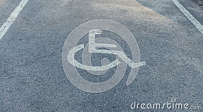 nternational markings for a handicapped parking. Disabled symbol sign on asphalt in parking space. I Stock Photo