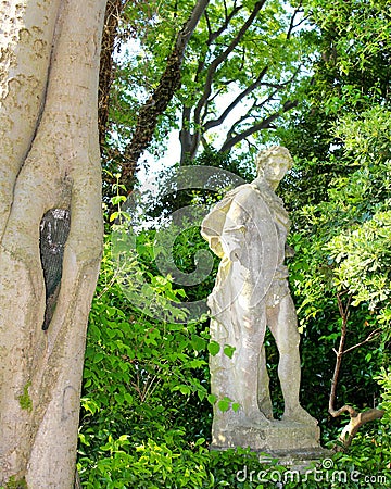 Ntique statue in a park near the waterfront in Venice Stock Photo