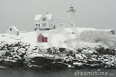 Nubble Lighthouse in Winter Snowstorm Stock Photo