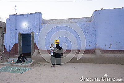 Nubian blue house at dusk with villagers Editorial Stock Photo
