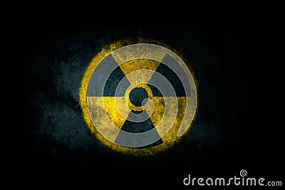 Nuclear energy radioactive ionizing atomic radiation round yellow symbol shape painted on massive concrete cement wall texture Stock Photo