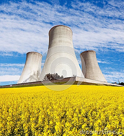 Nuclear power plant with field of rapeseed Stock Photo