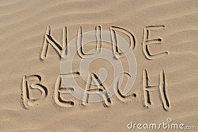 Nude beach letters written on the sand at the beach on a sunny day. Naked sunbathing. Naturalist lifestyle Stock Photo
