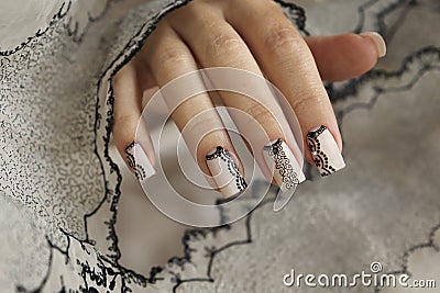 Nude manicure with graphic patterns and rhinestones Stock Photo