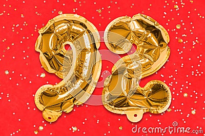The number of the balloon made of golden foil, the number ninety-two on a red background with sequins. Stock Photo