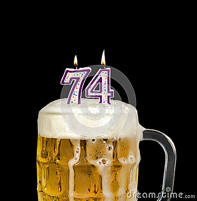 Number 74 candle in beer Stock Photo