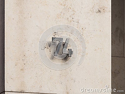 Number 74 on an Exterior House Wall Stock Photo