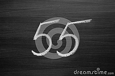 Number fifty five enumeration written with a chalk on the blackboard Stock Photo