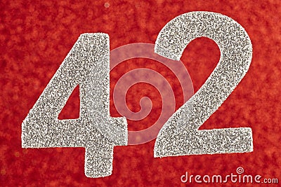 Number forty-two silver color over a red background. Anniversary Stock Photo