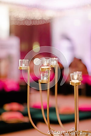 Number of glass cups containing multiple candles on a table Stock Photo