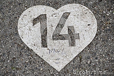 Number 14 in a heart painted on concrete Stock Photo