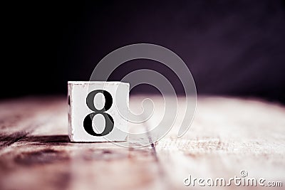 Number 8 isolated on dark background- 3D number eight isolated on vintage wooden table Stock Photo