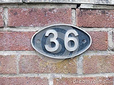 A number plate on a brick wall with 36 on it Stock Photo