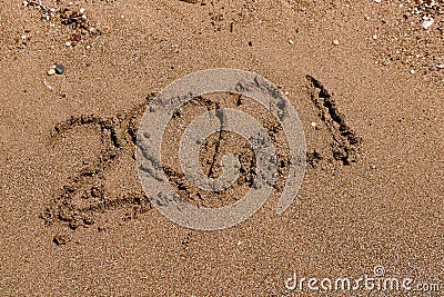 Number 2021 is written on the sand at sea...heart in the sand. Two thousand twenty one Stock Photo