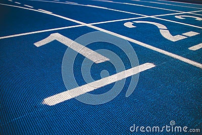 Numbered running track blue color. Starting position. Stock Photo