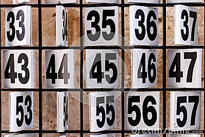 Numbers. Rusty plate of numbers for some game. Stock Photo
