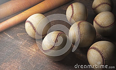 Numerous balls and bats on wooden desk Stock Photo