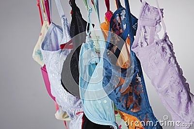 Numerous Colorful Bras Are Hung On A Close Line In A Studio Environment Stock Photo