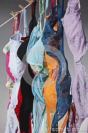 Numerous Colorful Bras Are Hung On A Close Line In A Studio Environment Stock Photo