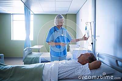 Nurse adjusting male patient s iv drip Stock Photo