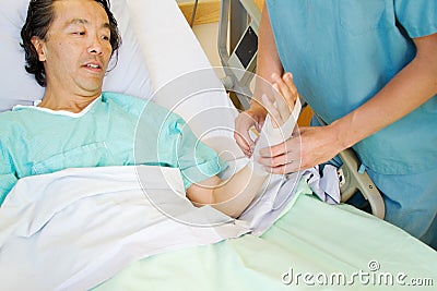 Nurse applying tensor to wrist Stock Photo