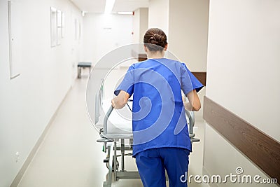 Nurse carrying hospital gurney to emergency room Stock Photo