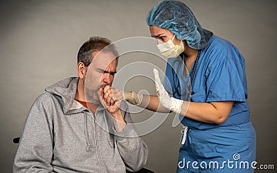Nurse comforts a sick older man coughing Stock Photo