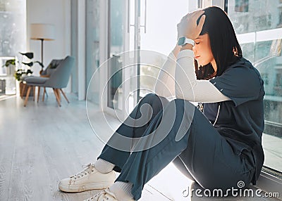 Nurse, depression and woman with stress in hospital after loss, grief or bad news in clinic. Mental health, healthcare Stock Photo