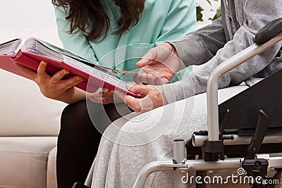 Nurse and disabled viewing photos Stock Photo