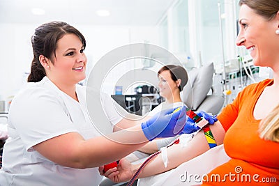 Nurse disinfecting puncture point before blood donation Stock Photo