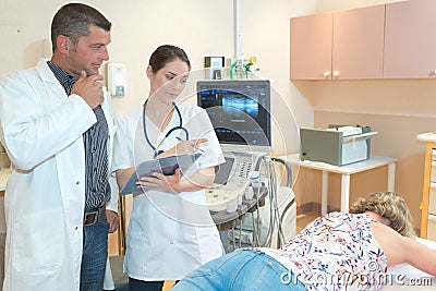 Nurse and doctor observing patients back Stock Photo