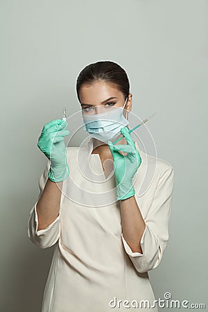 Nurse or doctor with syringe showing ampoule ready for injecting on white background. Medicine, cosmetology and vaccination Stock Photo