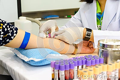 Nurse drawing blood sample from arm patient for blood test Stock Photo