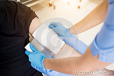 Nurse dressing wound for patient`s hand with burn injury Stock Photo