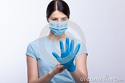 Nurse with face mask wear and checking protective gloves Stock Photo