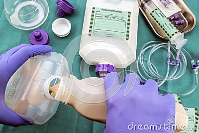 Nurse filling a bottle of enteral nutrition, Palliative Care, Conceptual Image Stock Photo