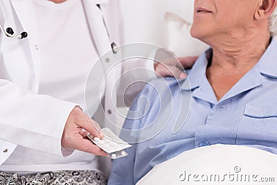 Nurse giving medicines Stock Photo