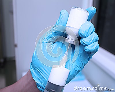 Nurse in gloves preparing solution of white drugs Stock Photo