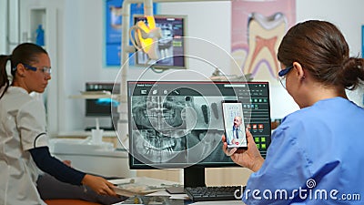 Nurse having video call with expert stomatologic medic Stock Photo